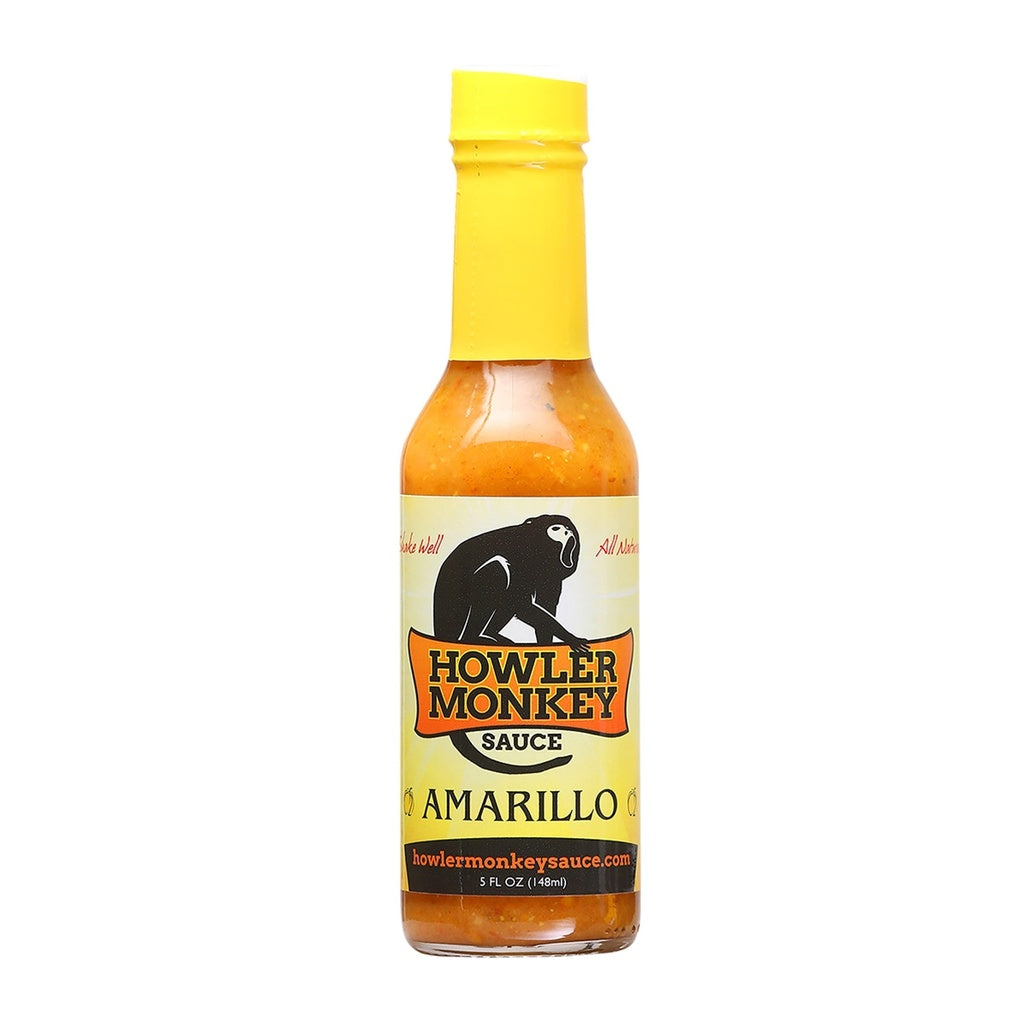 Howler Monkey Amarillo hot sauce bottle with yellow cap on a white background