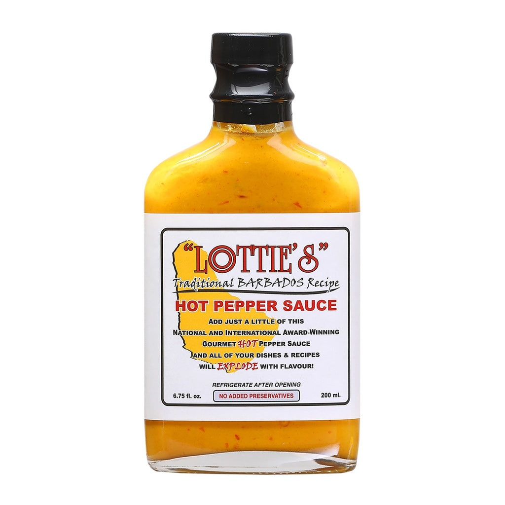 A square glass bottle of Lottieās Traditional Barbados Yellow Hot Pepper Sauce filled with a thick, bright yellow pepper sauce speckled with red. The bottle has a black cap and a white label with red, black, and green text that reads āLottieās Traditional Barbados Recipe ā Hot Pepper Sauce.ā The label includes an outline of Barbados and notes that it is a gourmet hot pepper sauce with no added preservatives.