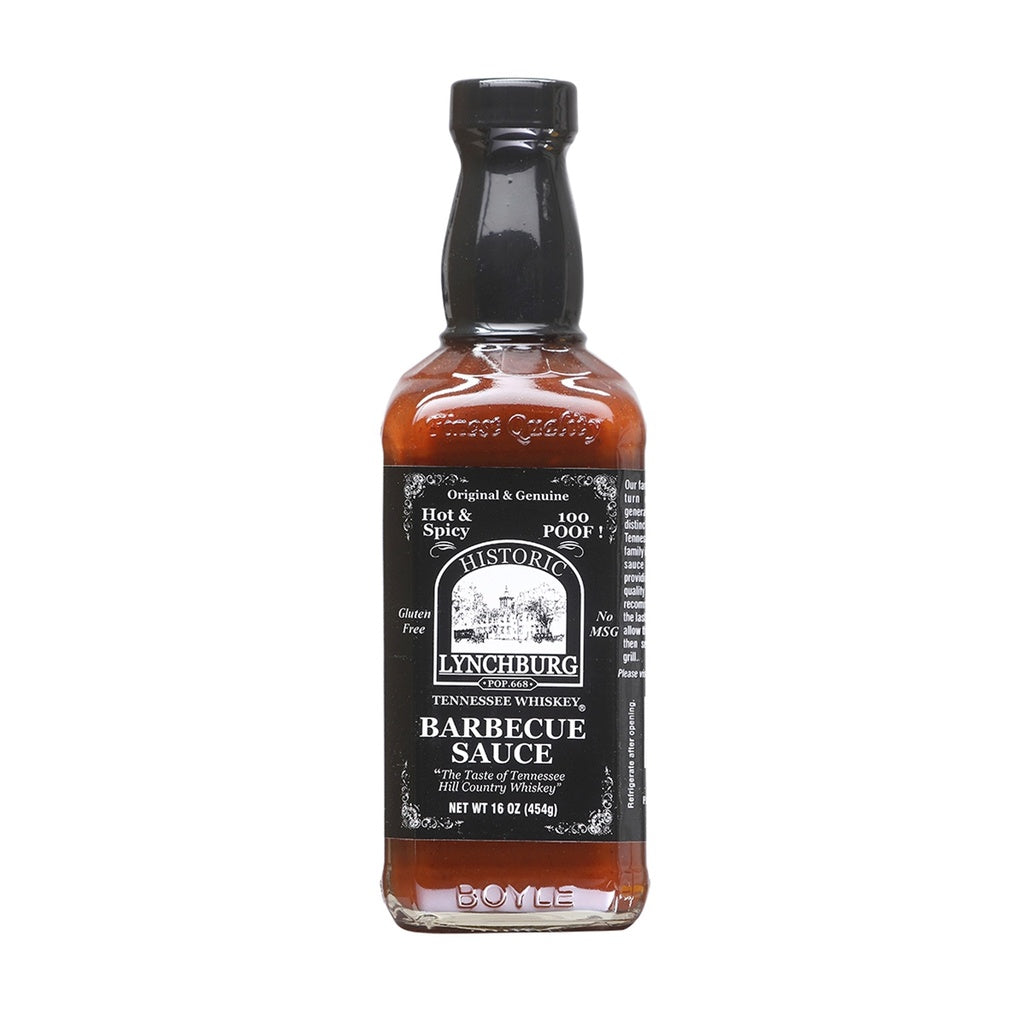 Glass bottle of Historic Lynchburg Tennessee Whiskey Hot & Spicy Barbecue Sauce with black label and black cap, filled with reddish-brown barbecue sauce; labeled 16 oz and marked 100 Poof.