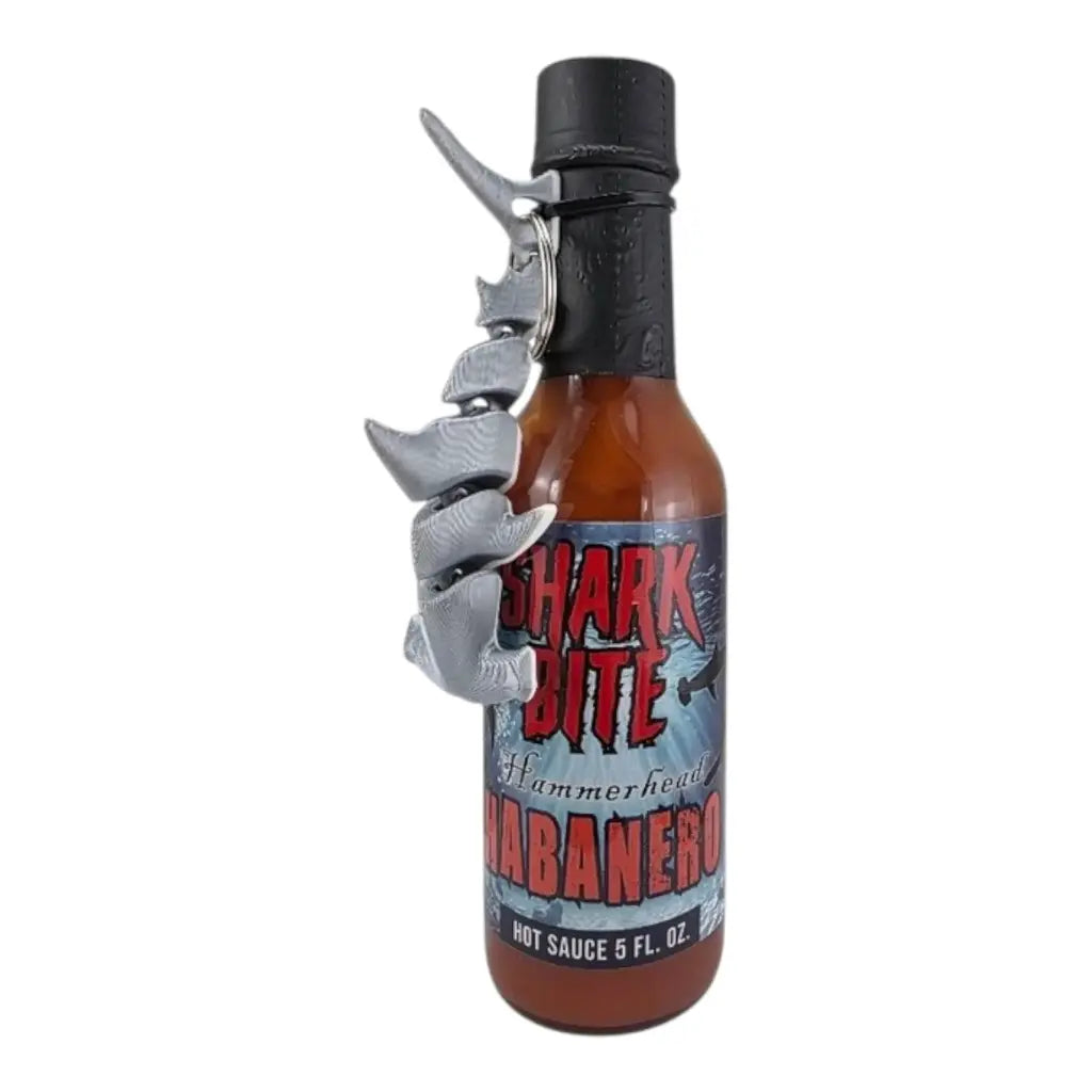 Shark Bite Hammerhead Habanero Hot Sauce 5 fl oz bottle with attached 3D articulating shark keychain and bold citrus habanero sauce UPC 701705500337