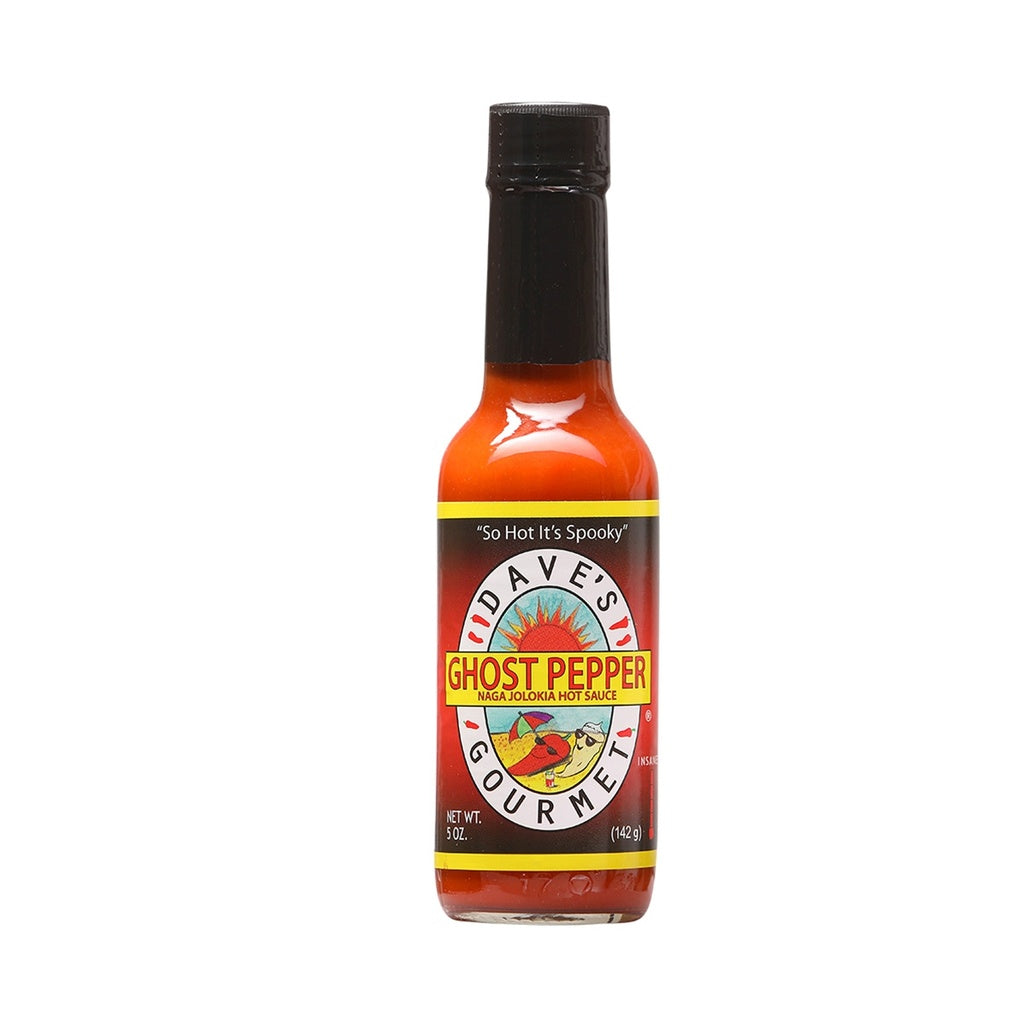 A 5-oz bottle of Dave’s Gourmet Ghost Pepper Naga Jolokia Hot Sauce with a bright red-orange sauce inside. The label features the Dave’s Gourmet sun logo and bold yellow text reading “GHOST PEPPER NAGA JOLOKIA HOT SAUCE,” along with the tagline “So Hot It’s Spooky.” The bottle has a black cap and displays “NET WT. 5 OZ (142 g).” UPC: 753469000882