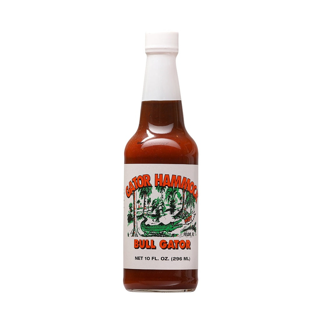 A glass bottle of Gator Hammock Bull Gator Barbecue Sauce with a white label showing a green alligator scene and the words βBull Gator,β net 10 fl oz (296 mL). UPC 748309000139.