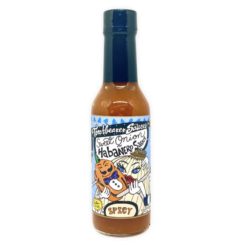 A bottle of Torchbearer Sweet Onion Habanero Sauce with a black cap and orange-brown sauce inside. The label features a cartoon of a blue-eyed character hugging a smiling onion, with bold text reading āSweet Onion Habanero Sauceā and āSpicy.ā