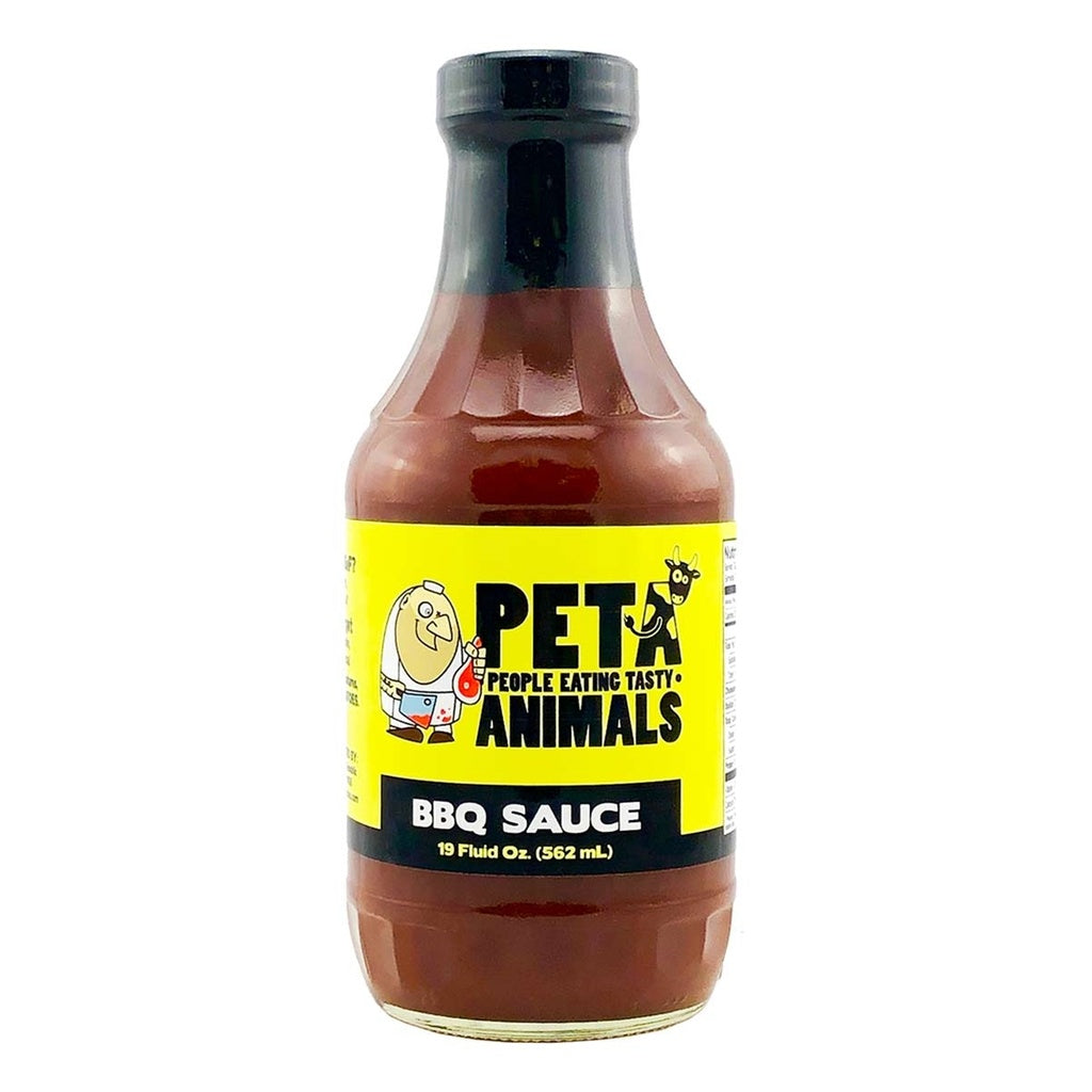 A 19-ounce bottle of PETA (People Eating Tasty Animals) BBQ Sauce with a black cap and dark brown barbecue sauce inside. The yellow label features a cartoon butcher holding a cleaver next to a cow, with bold text reading āPETA ā People Eating Tasty Animalsā and āBBQ Sauce.ā
