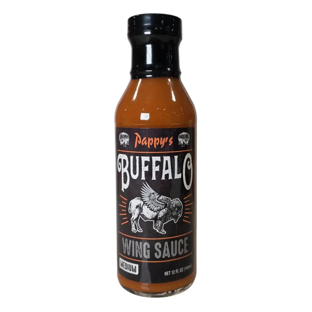 A bottle of Pappy’s Buffalo Wing Sauce (Medium). The sauce is orange and comes in a 12 fl oz bottle with a black cap. The label is black with white and orange text and features a winged buffalo illustration in the center.