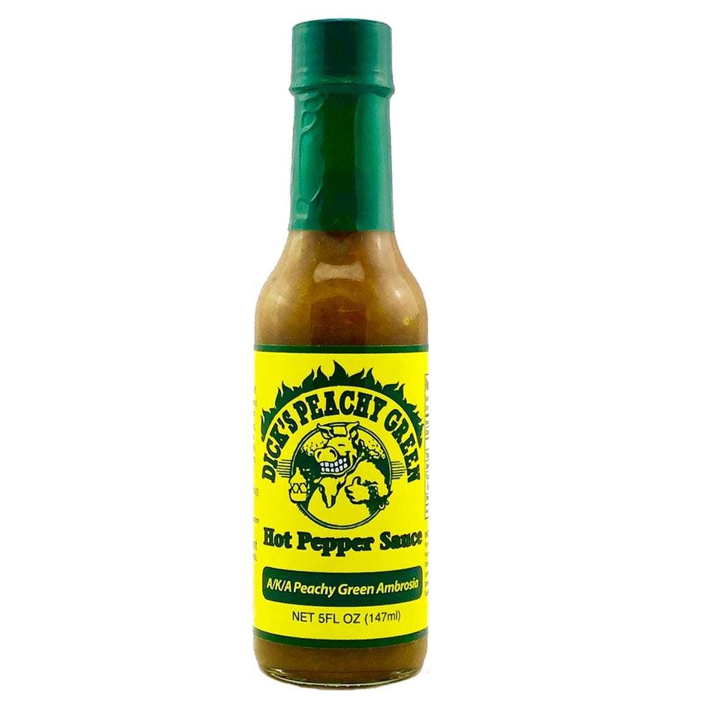 A 5-ounce bottle of Dirty Dick’s Peachy Green Hot Pepper Sauce with a dark green cap and bright yellow label. The label features the brand’s cartoon boar logo inside a flaming circle and bold text reading “Peachy Green Hot Pepper Sauce.”