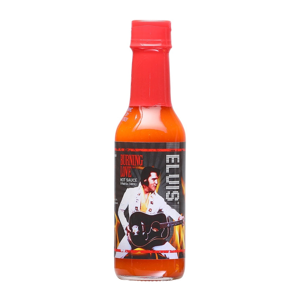 A 5 fl oz bottle of Elvis Burning Love Hot Sauce with a bold label featuring Elvis Presley in a white jumpsuit holding a guitar, set against flames. UPC: 870128008864.
