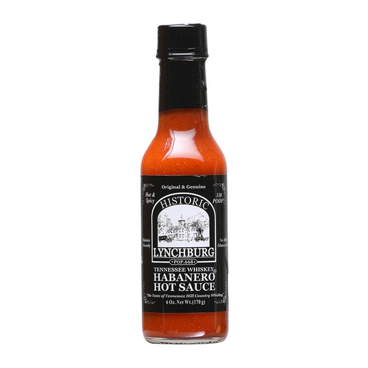 Glass bottle of Historic Lynchburg Tennessee Whiskey Habanero Hot Sauce with black label and black cap, filled with bright red-orange hot sauce; labeled 6 oz.