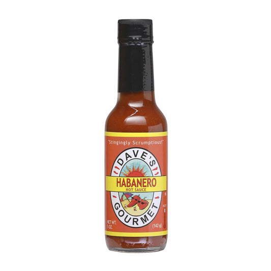 A 5-ounce bottle of Dave’s Gourmet Hurtin’ Habanero Hot Sauce with a black cap and orange label. The label displays the Dave’s Gourmet sun logo and the words “Habanero Hot Sauce.” The bottom shows “Net Wt. 5 oz (142 g).” The sauce inside is a deep orange-red color. UPC: 753469000165