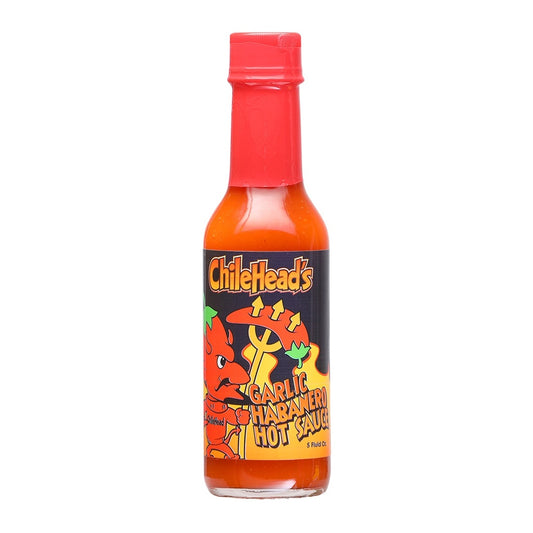 A glass bottle of Chilehead’s Garlic Habanero Hot Sauce with a red cap and illustrated label featuring a cartoon chile character, labeled “Garlic Habanero Hot Sauce,” 5 fluid ounces. UPC 700465772848.