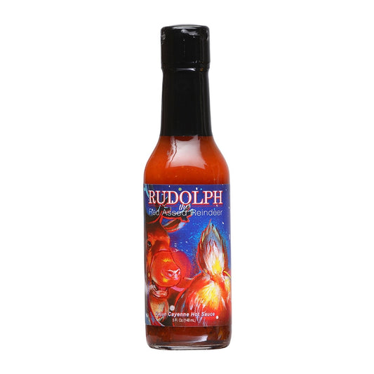 A bottle of Rudolph the Red-Assed Reindeer Cajun Cayenne Hot Sauce filled with bright red sauce and topped with a black cap. The label features a fiery cartoon-style reindeer with glowing red eyes and flames bursting behind it against a dark blue night sky. The text reads “Rudolph the Red-Assed Reindeer” and “Cajun Cayenne Hot Sauce,” with the size listed as 5 fl. oz. (148 mL).