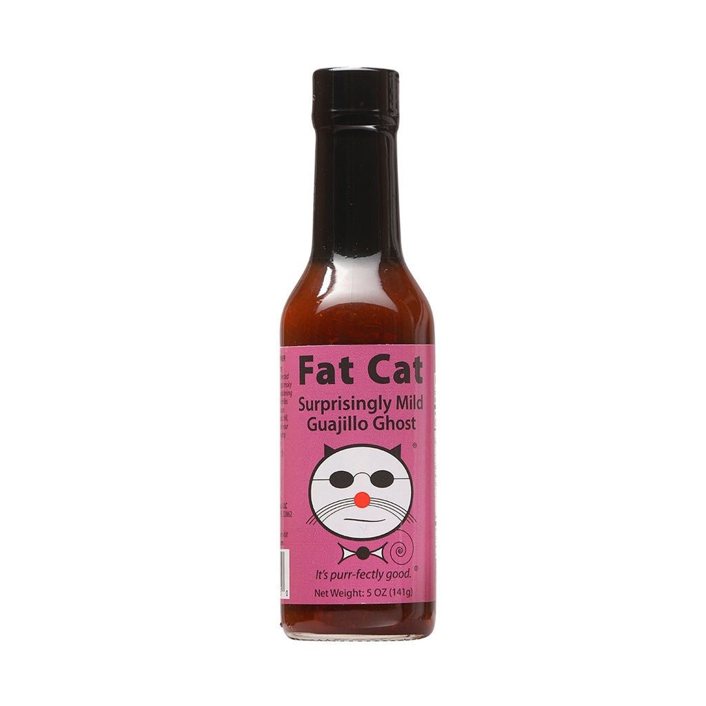 A bottle of Fat Cat Surprisingly Mild Guajillo Ghost Hot Sauce with purple label