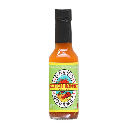 A 5-oz glass bottle of Dave’s Gourmet Scotch Bonnet Hot Sauce with a bright orange label. The label features the Dave’s Gourmet sun logo and bold red-yellow type reading “Scotch Bonnet Hot Sauce.” The sauce inside is a vivid orange-red liquid, showing its pepper-rich base. UPC: 753469000769