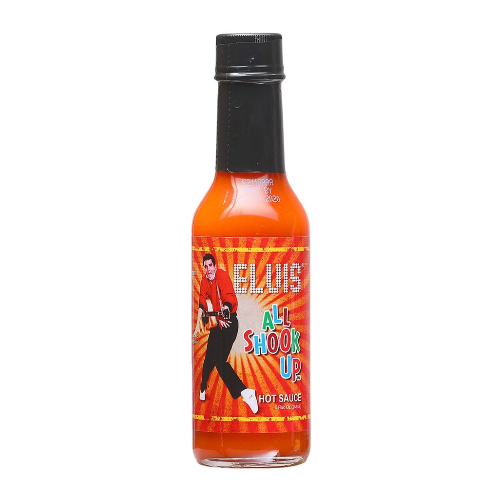 A 5 fl oz bottle of Elvis All Shook Up Hot Sauce with an orange-red label showing Elvis Presley in a lively pose. The bright, retro design conveys character and medium heat. UPC: 870128009953.