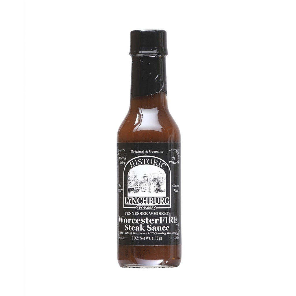 Glass bottle of Historic Lynchburg Tennessee Whiskey WorcesterFIRE Steak Sauce with black label and black cap, filled with dark brown steak sauce; labeled 6 oz.