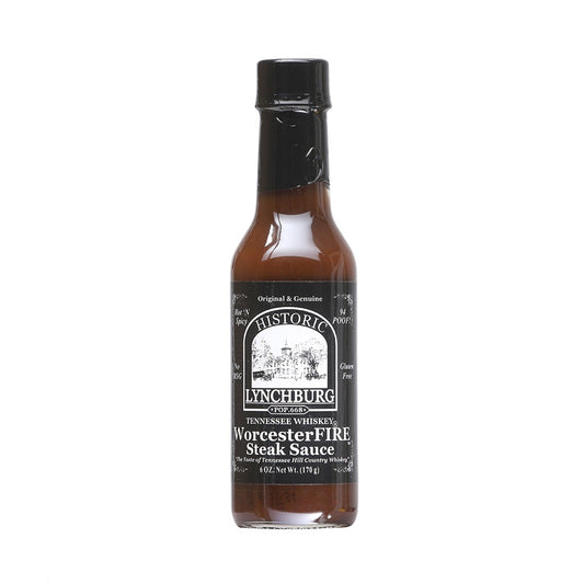 Glass bottle of Historic Lynchburg Tennessee Whiskey WorcesterFIRE Steak Sauce with black label and black cap, filled with dark brown steak sauce; labeled 6 oz.
