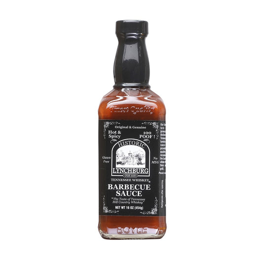 Glass bottle of Historic Lynchburg Tennessee Whiskey Hot &amp; Spicy Barbecue Sauce with black label and black cap, filled with reddish-brown barbecue sauce; labeled 16 oz and marked 100 Poof.