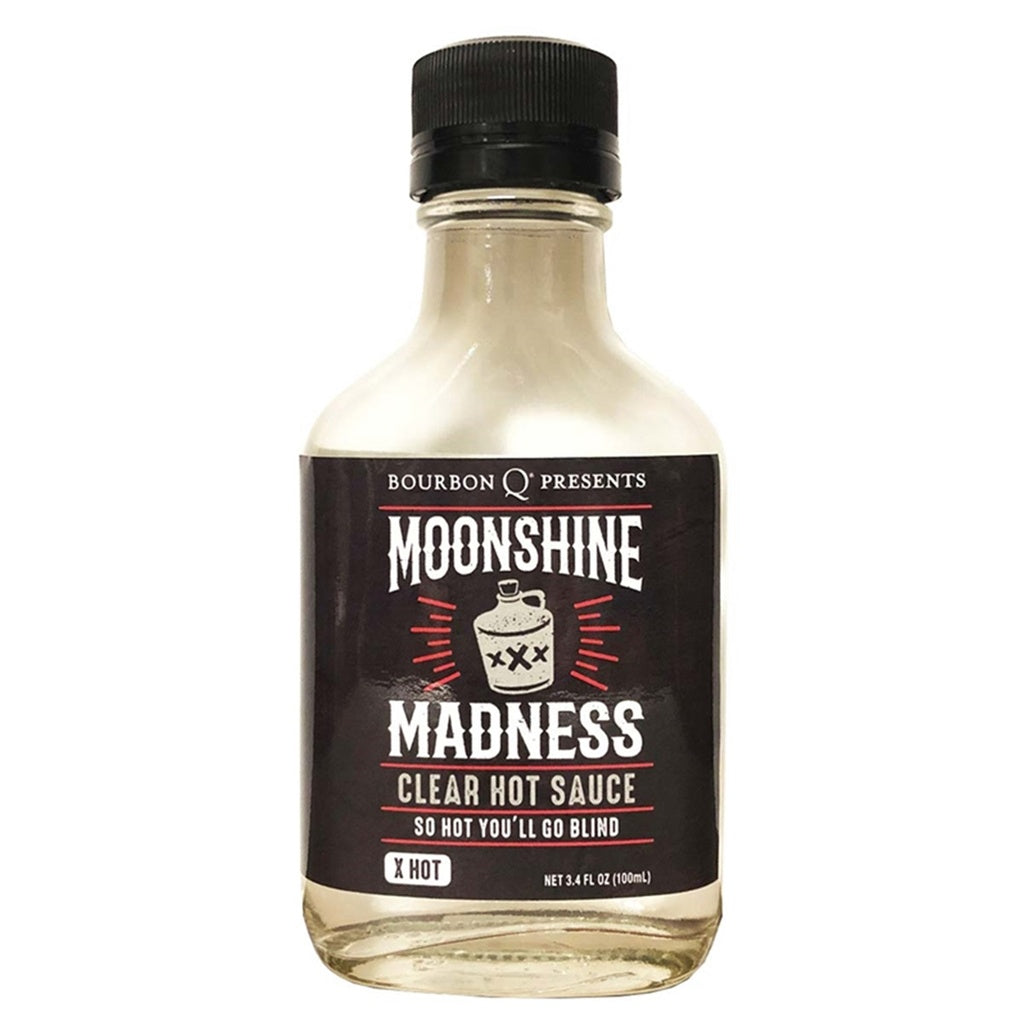 A clear 3.4 fl oz bottle of Bourbon Q’s “Moonshine Madness” Clear Hot Sauce. The bottle has a black screw cap and a black label featuring a white moonshine jug marked “XXX” in the center with red accent lines. The label text reads: “Moonshine Madness,” “Clear Hot Sauce,” “So Hot You’ll Go Blind,” and “X Hot.” The sauce inside appears completely clear, matching the “moonshine” theme.