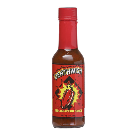 A bottle of Deathwish Red Jalapeño Hot Sauce filled with reddish-brown sauce. The bottle has a bright red cap and a bold red label featuring a bursting red jalapeño pepper in the center. The label reads “Deathwish” at the top and “Red Jalapeño Sauce” near the bottom, with the size listed as 5 fl. oz. (147 mL).