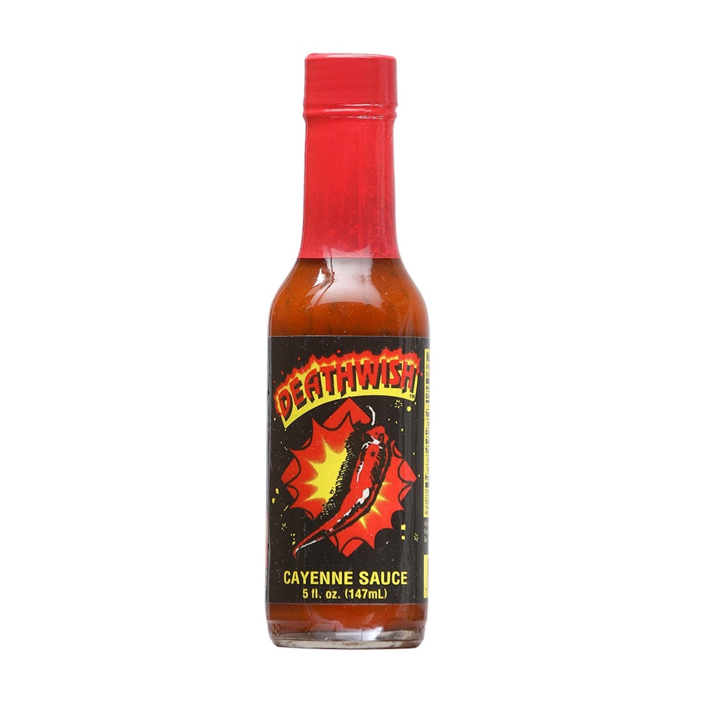 A bottle of Deathwish Cayenne Hot Sauce filled with a bright red-orange sauce. The bottle has a red cap and a black label featuring a fiery red cayenne pepper exploding at the center with the word “Deathwish” across the top. The label reads “Cayenne Sauce” and shows the size as 5 fl. oz. (147 mL).
