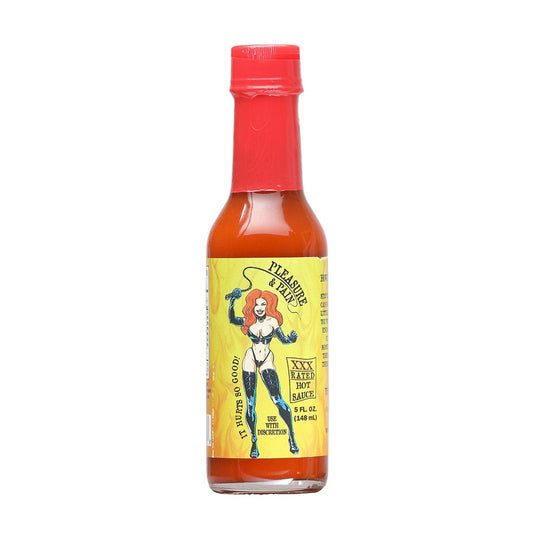 A 5 fl oz bottle of Pleasure and Pain XXX Rated Hot Sauce. The bottle has a red wax-style seal over the cap and contains a bright red-orange sauce. The yellow label features a cartoon woman in black leather attire holding a whip, with text reading “Pleasure & Pain,” “XXX Rated Hot Sauce,” and “Use With Discretion.” The label also includes the phrase “It Hurts So Good!”