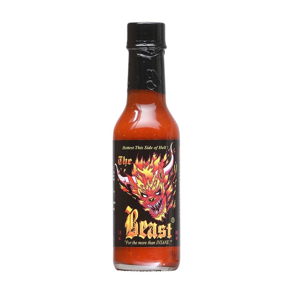 Glass bottle of The Beast Hot Sauce with black label featuring a flaming demonic beast illustration, filled with bright red-orange hot sauce; labeled 5 fl oz.