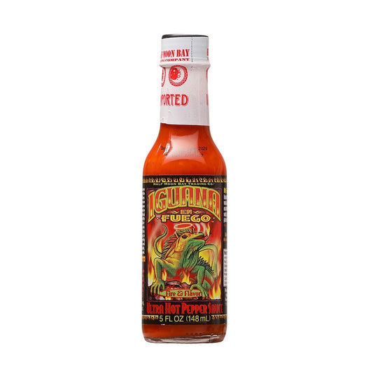 Image of a 5 fl oz bottle of Iguana En Fuego Ultra Hot Pepper Sauce featuring a bright red-orange sauce, a detailed tropical-themed label with an iguana breathing fire, and the text “Ultra Hot Pepper Sauce” at the bottom. UPC: 751059900789