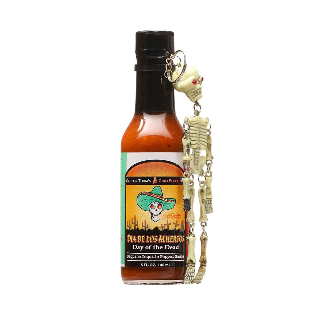 Bottle of Captain Thom’s Day Of The Dead Hot Sauce with colorful label and attached skeleton keychain, 5 fl oz bottle, UPC 689076357852