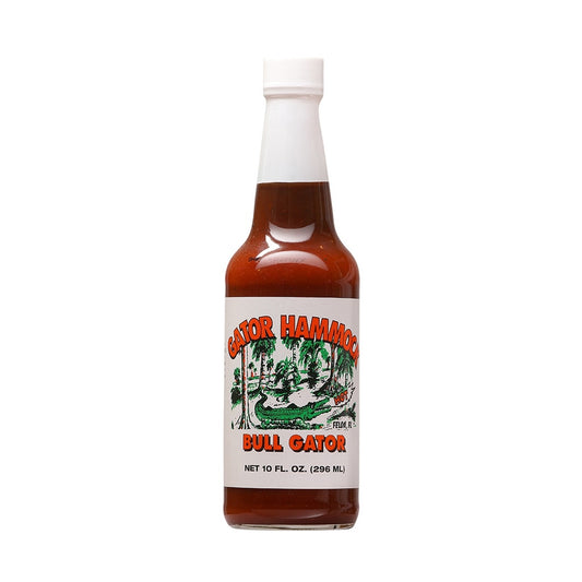 A glass bottle of Gator Hammock Bull Gator Barbecue Sauce with a white label showing a green alligator scene and the words “Bull Gator,” net 10 fl oz (296 mL). UPC 748309000139.