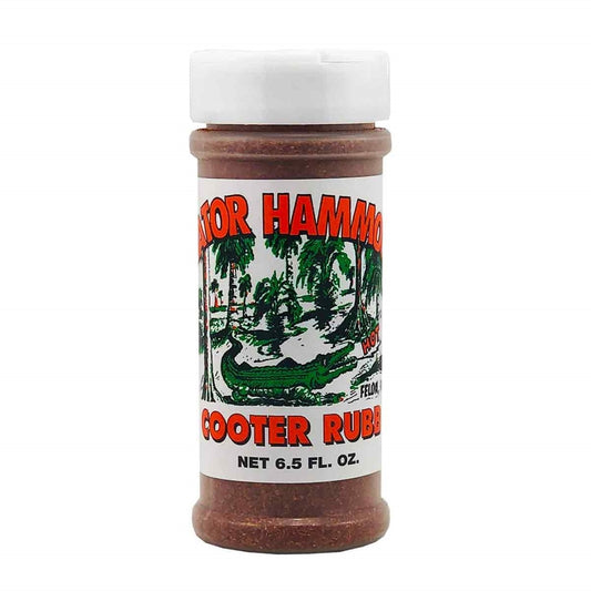 A plastic shaker bottle of Gator Hammock Cooter Rub with a white label showing a green alligator swamp scene and the words “Cooter Rub,” net 6.5 oz. UPC 748309010008.