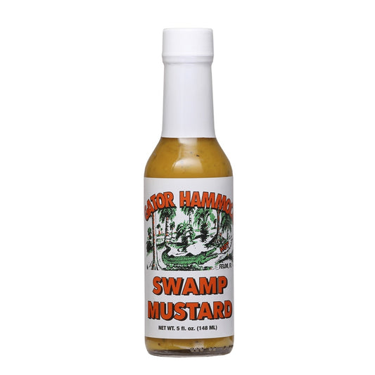 A glass bottle of Gator Hammock Swamp Mustard with a white cap and a label featuring a green alligator swamp scene and the words “Swamp Mustard,” net 5 fl oz. UPC 748309447224.