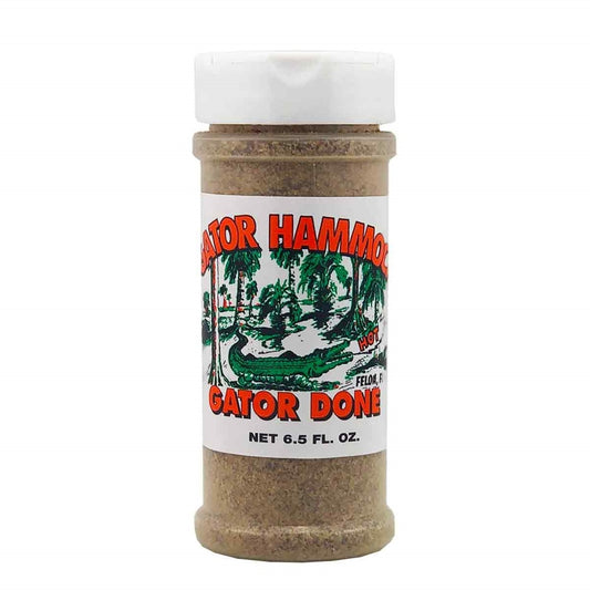 A plastic shaker bottle of Gator Hammock Gator Done seasoning with a white label showing a green alligator swamp scene and the words “Gator Done,” net 6.5 fl oz. UPC 748309111057.