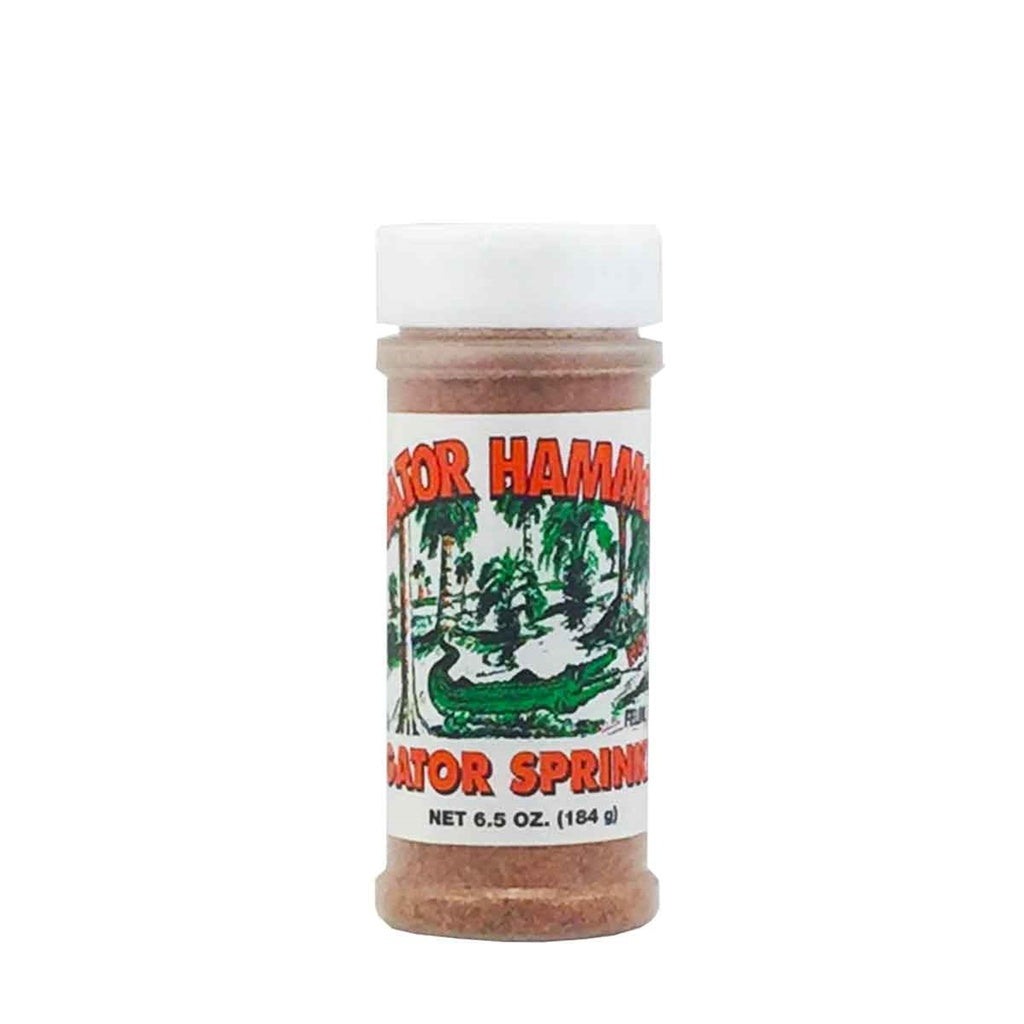A plastic seasoning bottle of Gator Hammock Gator Sprinkle with a white cap and a label featuring a green alligator scene and the words “Gator Sprinkle,” net weight 6.5 oz (184 g). UPC 748309419573.