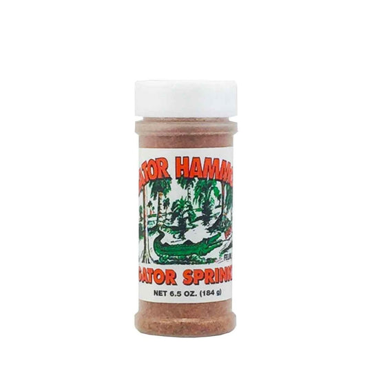A plastic seasoning bottle of Gator Hammock Gator Sprinkle with a white cap and a label featuring a green alligator scene and the words “Gator Sprinkle,” net weight 6.5 oz (184 g). UPC 748309419573.
