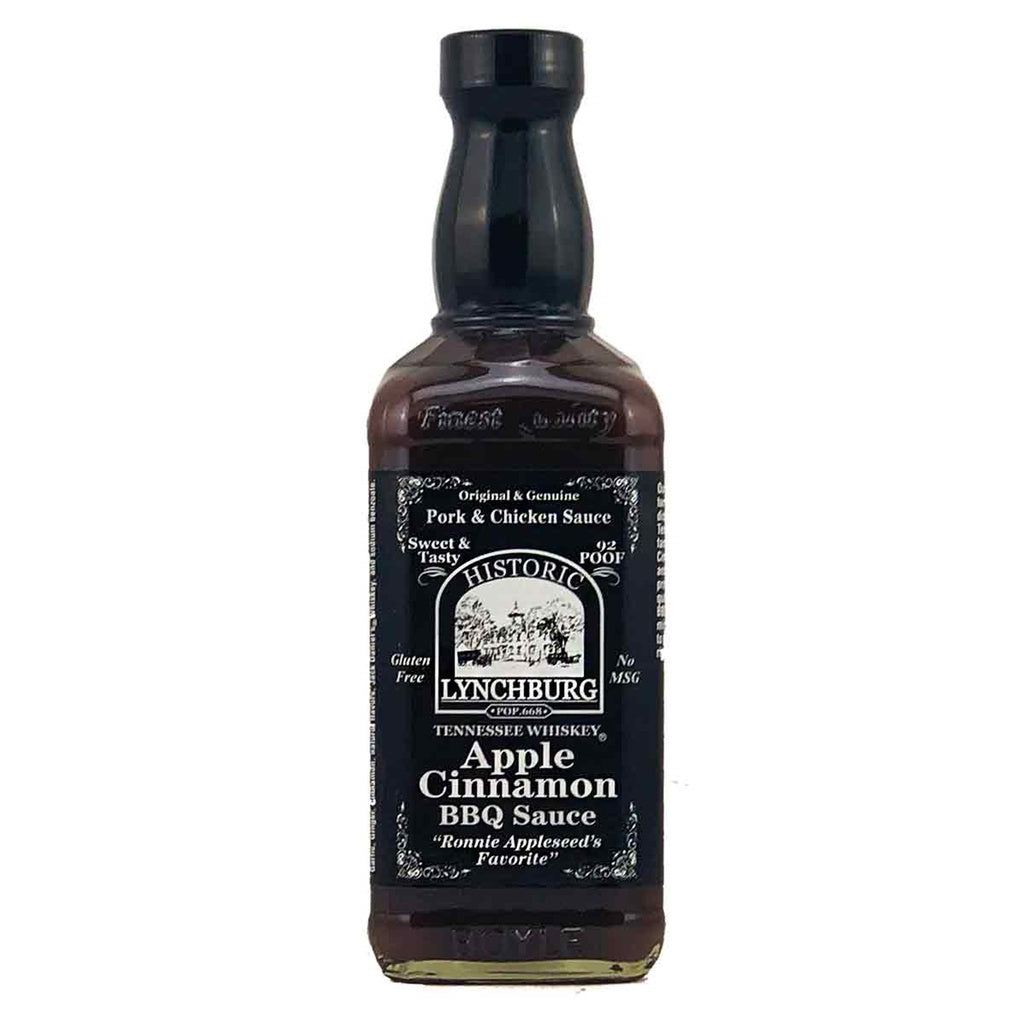 Glass bottle of Historic Lynchburg Tennessee Whiskey Apple Cinnamon BBQ Sauce with dark label, black cap, and rich brown sauce inside; labeled 16 fl oz.