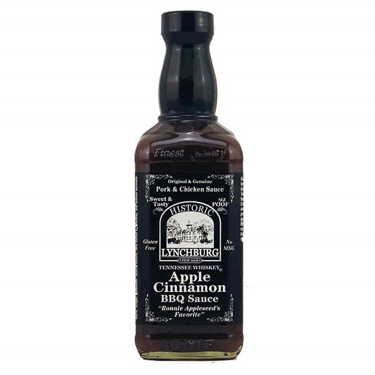 Glass bottle of Historic Lynchburg Tennessee Whiskey Apple Cinnamon BBQ Sauce with dark label, black cap, and rich brown sauce inside; labeled 16 fl oz.