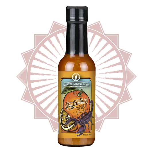 Bottle of Heartbreaking Dawn’s Skylarking Anytime Hot Sauce, 5 fl oz glass bottle with orange citrus-themed label