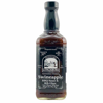 Glass bottle of Historic Lynchburg Tennessee Whiskey Swineapple Rib Glaze &amp; BBQ Sauce with dark label, black cap, and rich brown sauce inside; labeled 16 fl oz.