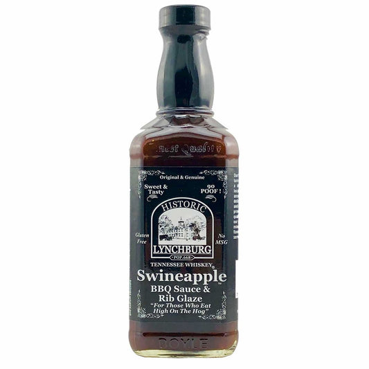 Glass bottle of Historic Lynchburg Tennessee Whiskey Swineapple Rib Glaze &amp; BBQ Sauce with dark label, black cap, and rich brown sauce inside; labeled 16 fl oz.