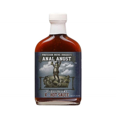 A bottle of Professor Payne Indeass's Anal Angst X-Hot Hot Sauce, featuring a bold label and fiery design. The sauce is known for its intense heat and flavorful ingredients, including habanero peppers, soy sauce, vinegar, Worcestershire sauce, garlic, and xanthan gum. The hot sauce is shown with a caption mentioning its availability exclusively at PepperHotSpot.com.