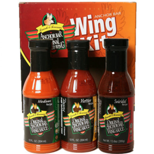 A boxed Anchor Bar Wing Kit containing three bottles of Original Anchor Bar Buffalo Wing Sauce. The box is red and orange with large white text reading “Wing Kit.” Inside the window are three labeled bottles: Suicidal Recipe, Hotter Recipe, and Medium Recipe.