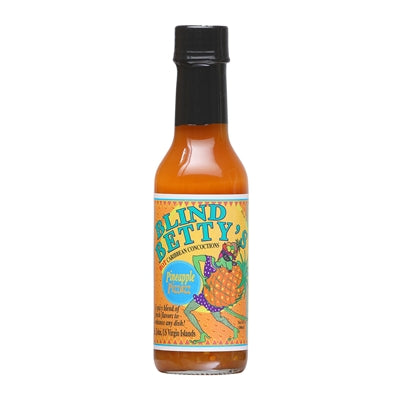 A vibrant image featuring a bottle of Blind Betty's Pineapple Pizzazz Hot Sauce with a background of tropical elements, including a pineapple, flames, and hula dancers. The text on the image promotes the sauce's tropical flavor and versatility, along with its ingredients and nutritional information. UPC: 830139000028.