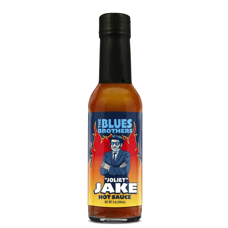 A bottle of Blues Brothers Jake Hot Sauce with a musical-themed label featuring an illustration of a microphone, guitar, and musical notes. The text reads "Blues Brothers Jake Hot Sauce - Ignite Your Taste Buds with a Sizzling Sensation! UPC: 647293010288