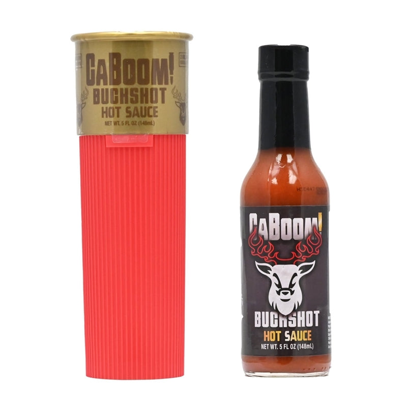 A bottle of CaBoom Buck Shot Hot Sauce designed with a shotgun shell-themed label featuring an illustration of a shotgun shell and the text "CaBoom Buck Shot Hot Sauce: Blast Your Taste Buds to Flavor Town! UPC: 647293010257