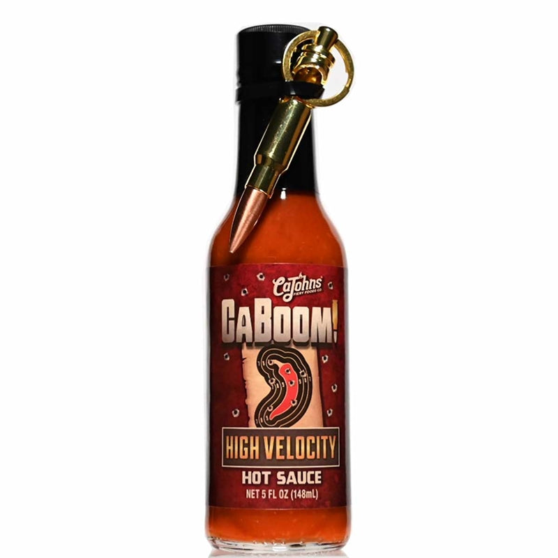 A bottle of CaBoom! High Velocity Hot Sauce designed with a bullet-themed label featuring an illustration of a bullet and the text "CaBoom! High Velocity Hot Sauce: Unleash the Flavor Firepower! UPC: 647293010141