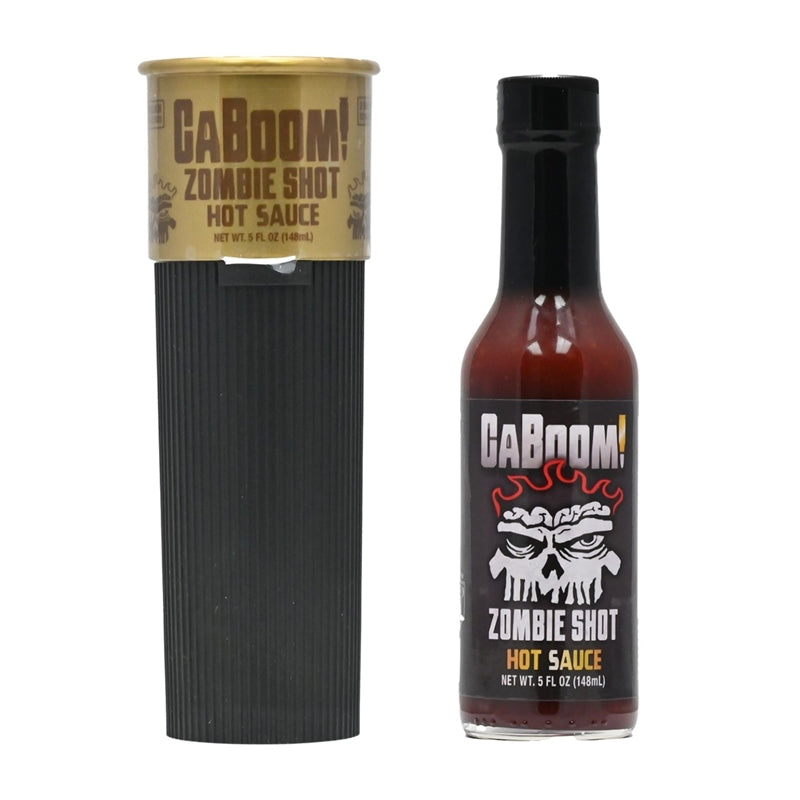 A bottle of CaBoom! Zombie Shot Hot Sauce designed like a shotgun shell, with a zombie-themed label featuring an illustration of a zombie and the text "CaBoom! Zombie Shot Hot Sauce: Survive the flavor apocalypse! UPC: 647293010264.