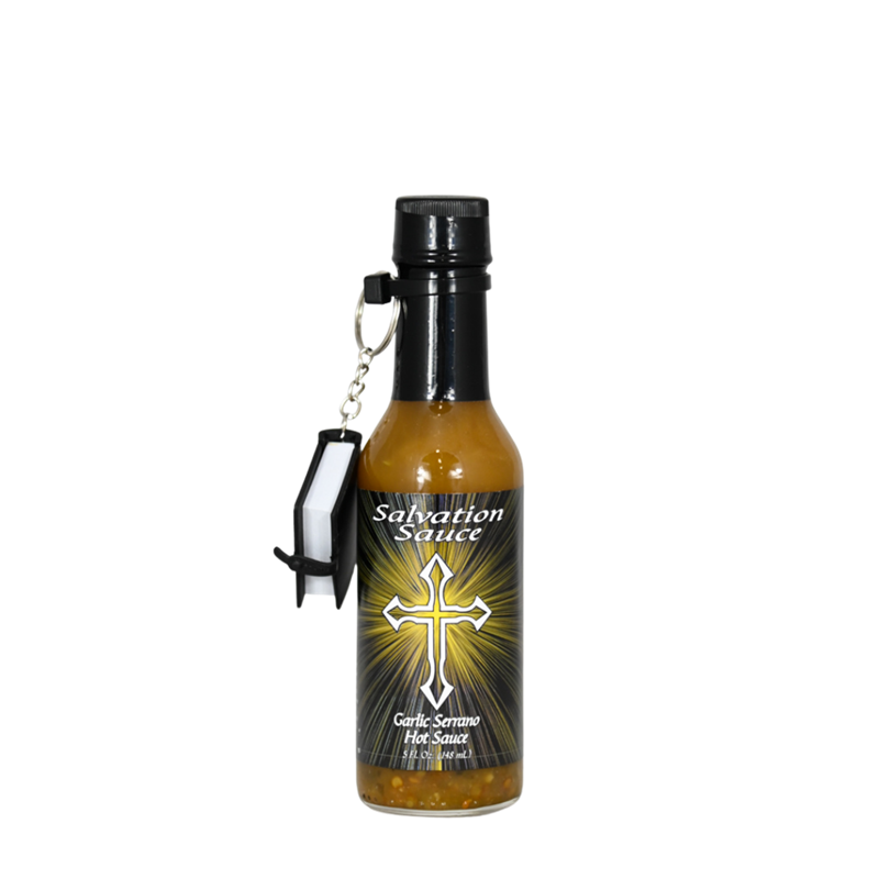 A bottle of Salvation Sauce Garlic Serrano, featuring a fiery design with the Salvation Sauce logo and an illustration of a serrano pepper. The 5 oz. bottle contains habanero and serrano peppers, garlic, vinegar, lime, and salt. Each bottle comes with a mini Bible. UPC: 188628000838.