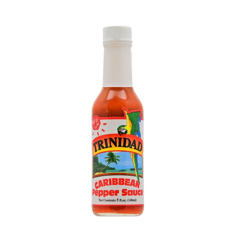 A bottle of Trinidad Caribbean Pepper Sauce - Medium, featuring a vibrant label with the Trinidad logo, an illustration of peppers, and the Caribbean flag colors. The 5 oz. bottle contains a flavorful blend of cayenne and habanero peppers, onions, mustard, thyme, basil, salt, bell pepper, celery, ginger, garlic, and natural gum. UPC: 095488100205.