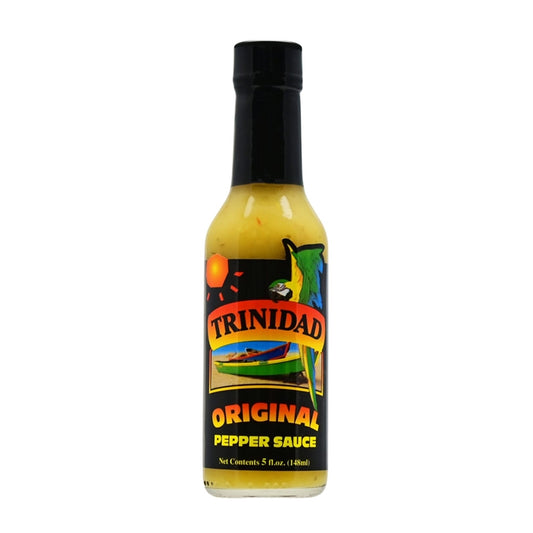 A bottle of Trinidad Original Pepper Sauce, featuring a vibrant label with tropical colors, palm trees, and the Trinidad and Tobago flag. The 5 oz. bottle contains a blend of onions, habanero peppers, vinegar, green peppers, celery, mustard, ginger, garlic, salt, thyme, basil, and other fine herbs. UPC: 095488100014.