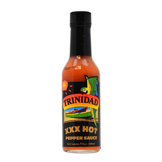 A bottle of Trinidad XXX Hot Pepper Sauce, featuring a vibrant label with tropical colors, palm trees, and the Trinidad and Tobago flag. The 5 oz. bottle contains a blend of habanero peppers, onions, vinegar, green peppers, celery, mustard, ginger, garlic, salt, thyme, basil, and other fine herbs. UPC: 095488100038.